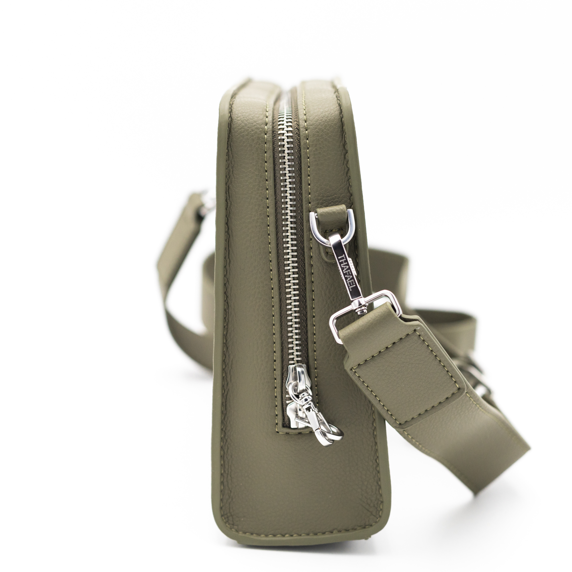 Side profile of the La Trotteuse anti-theft crossbody bag in olive green