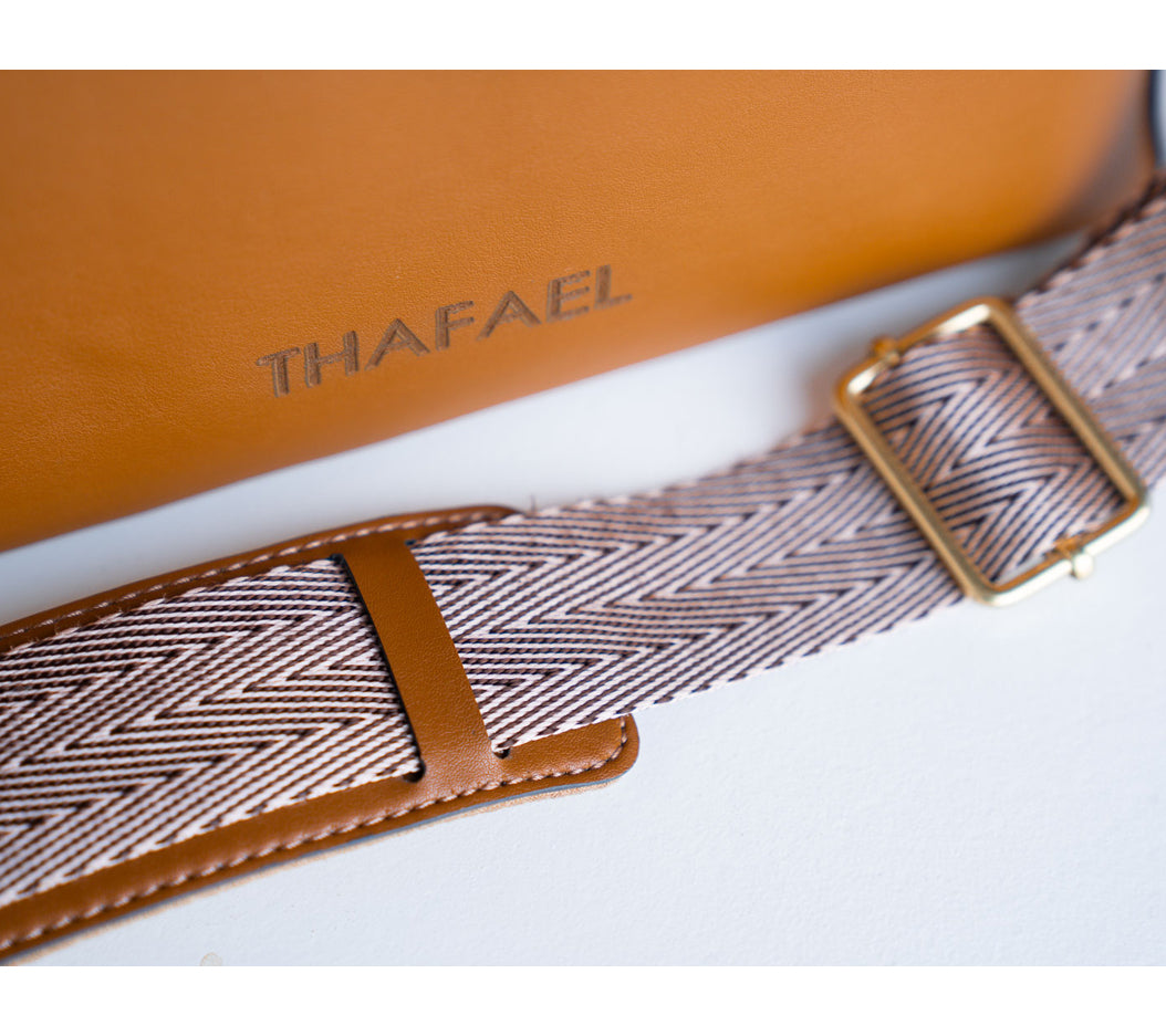 Close-up of slash-proof strap on Thafael crossbody travel bag showing reinforced anti-theft construction